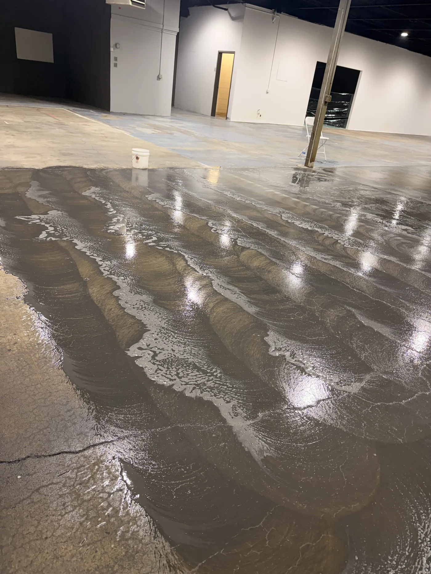 Warehouse floor being scrubbed and refinished